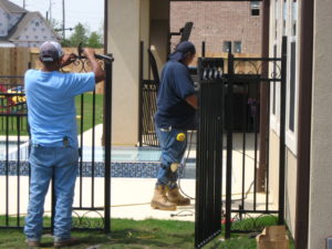 wrought iron gate being installed in sugar land