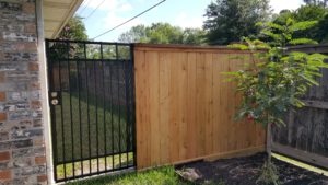 wood fence with wrought iron gate in sugar land