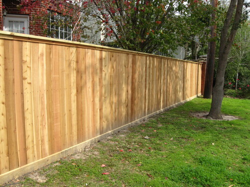 wood fence next to a home