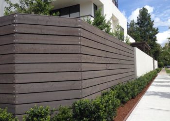 wood fence next to a commercial building