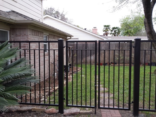 wrought iron fence in the woodlands