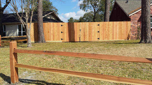 wooden fence next to a conroe home