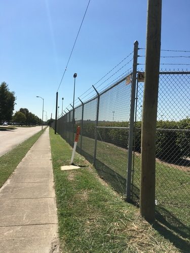 chain link fence on the side of the road