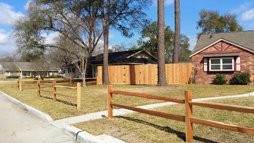 wood fence next to a home in the woodlands