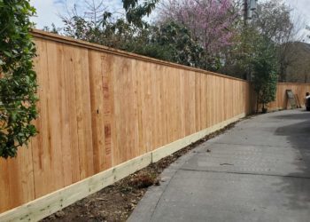 wood fence next to a road