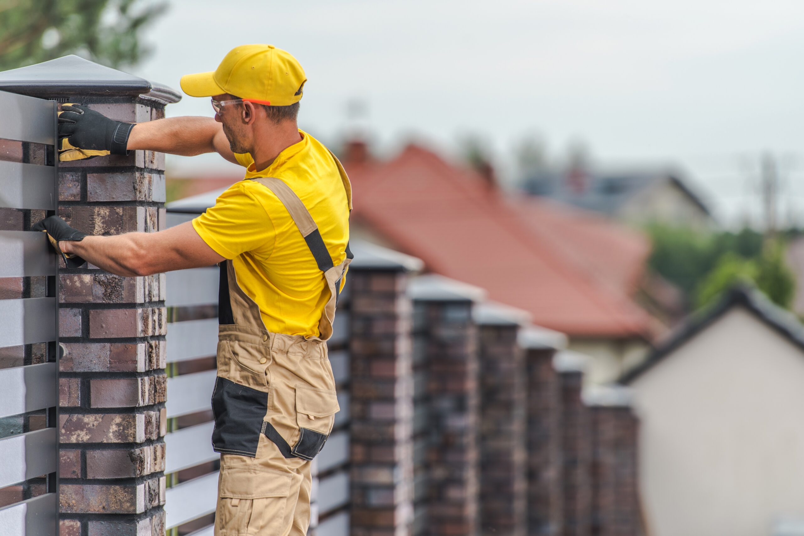 fence contractor building a brick fence